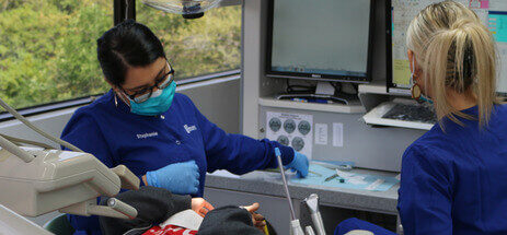 Two dental hygienists performing treatment in a pediatric dental office in Austin, Texas